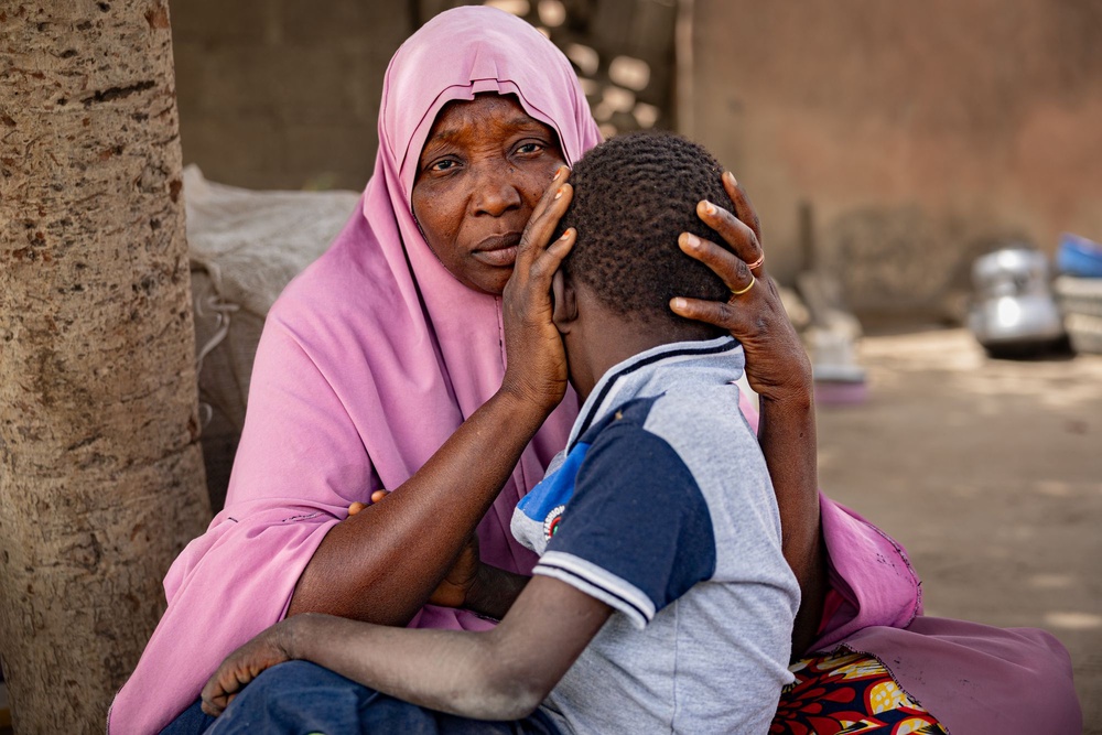 Isa, holds her son Ahmed, who was found after a year in captivity and came back unable to speak his native language (Bel Trew/The Independent)