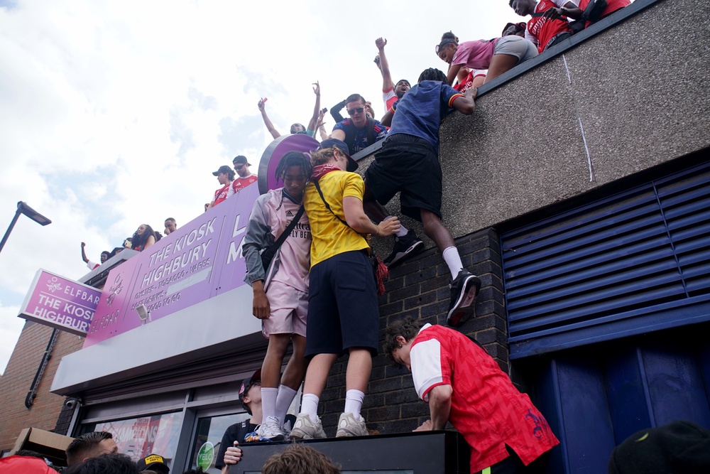 Arsenal fans climb on top of Highbury & Islington Station (Gareth Fuller/PA) (PA Wire)