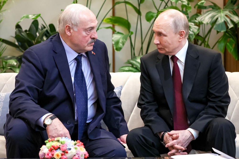 Russian President Vladimir Putin, right, speaks with Belarusian President Alexander Lukashenko on the sidelines of the Supreme Eurasian Economic Union summit in Astana, Kazakhstan, Friday, May 29 (AP)