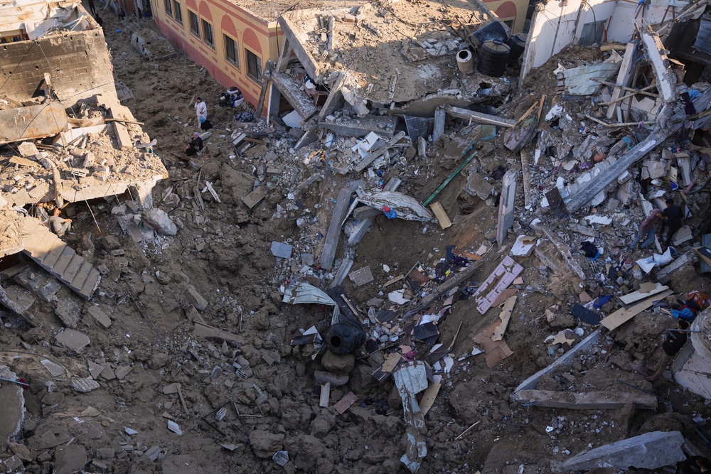 Palestinian women inspect the rubble of a building destroyed in an Israeli airstrike in Deir al-Balah, in the central Gaza Strip, Friday, May 29, 2026 (AP)