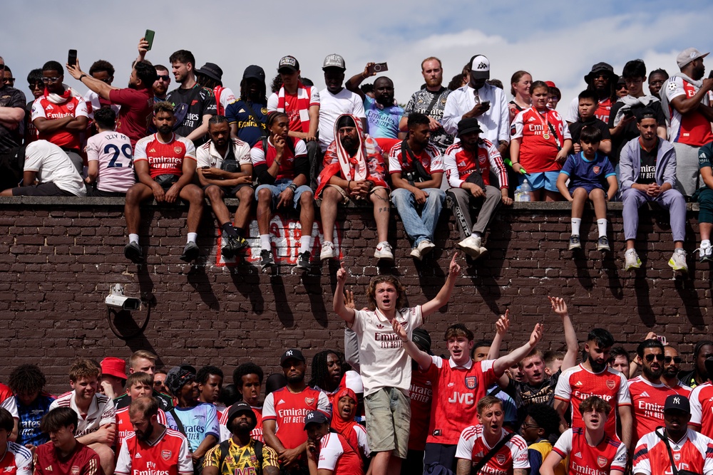Arsenal fans on top of Highbury and Islington Station watching the parade (Gareth Fuller/PA) (PA Wire)