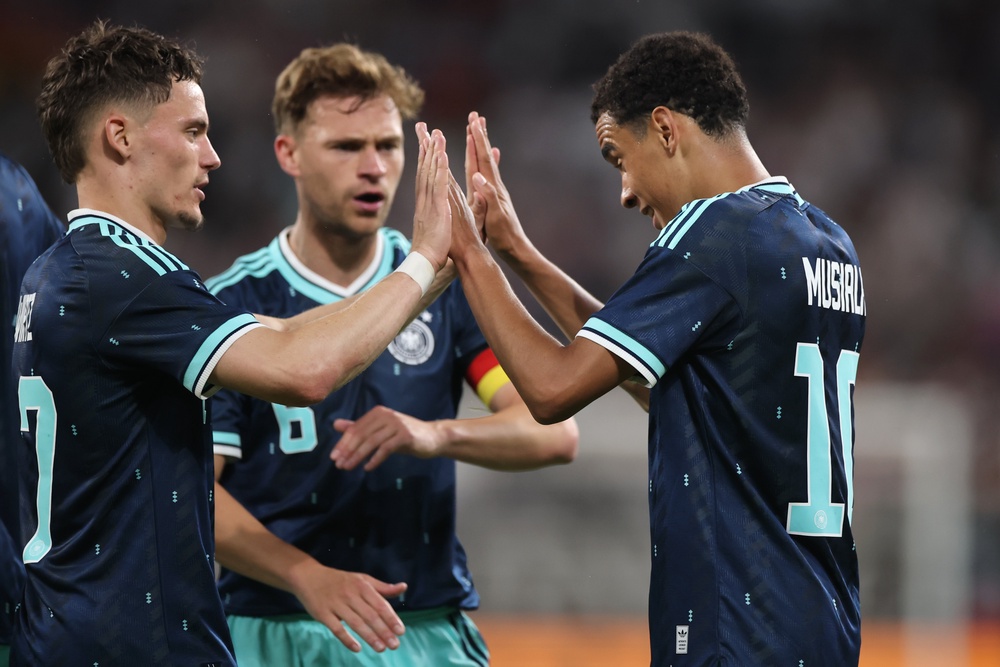Jamal Musiala of Germany celebrates the team's fourth goal against Finland with teammates Joshua Kimmich and Florian Wirtz (Getty)