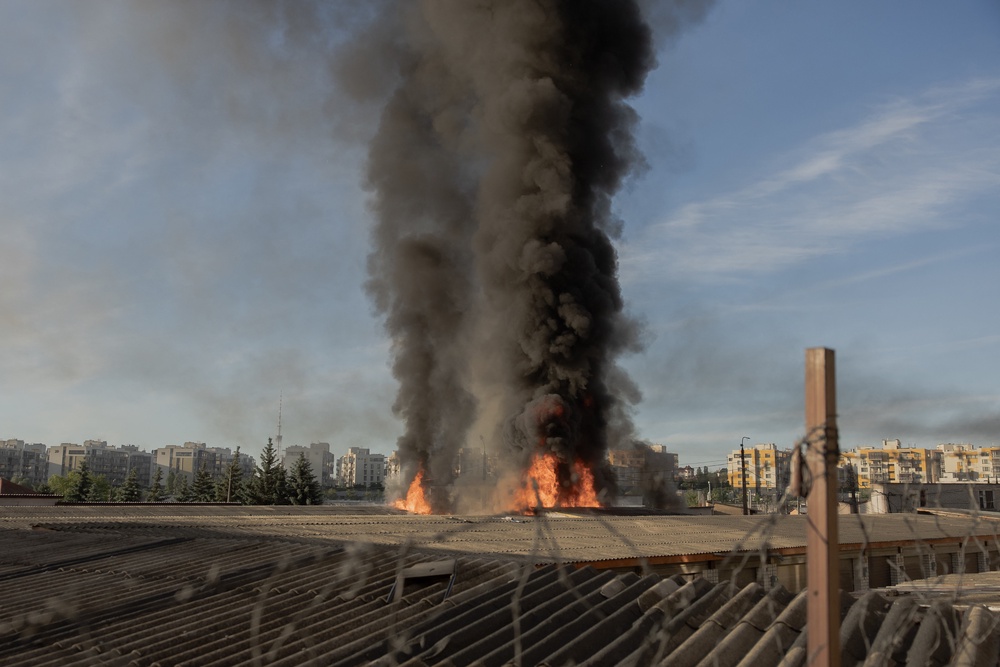 Smoke and flames rise from garages damaged during strikes in Kyiv (AFP/Getty)