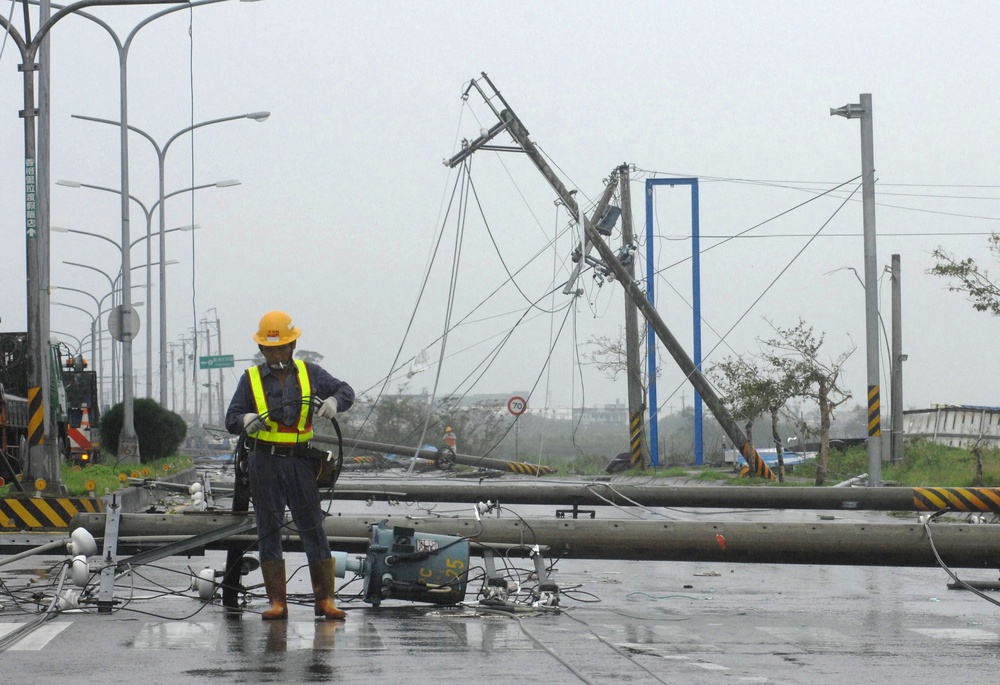 Workers attempt to repair electricity lines and poles that were toppled by Typhoon Jaigmi in Suao, a coastal town in Taiwan's northeastern Ilan county (AFP/Getty)