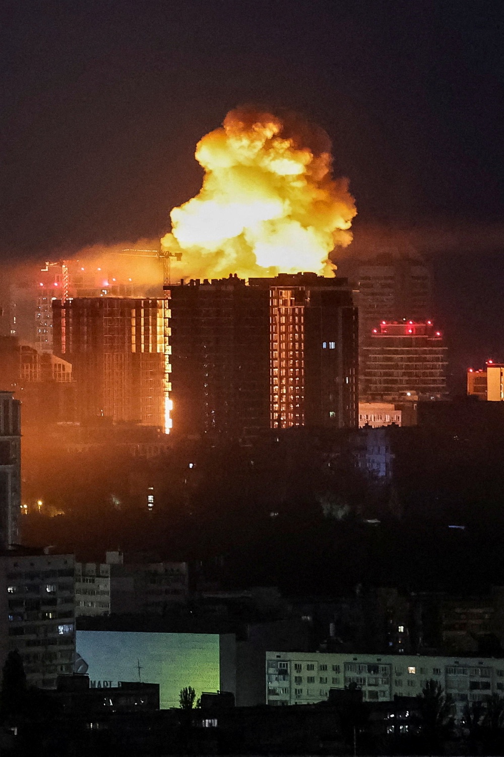 An explosion lights up the sky over the city during a Russian missile and drone strike in Kyiv overnight (Reuters)