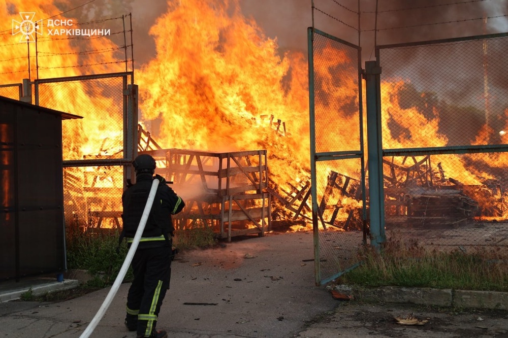 A rescue worker puts out a fire of a storage facility after a Russian strike on Kharkiv region, on Tuesday (Ukrainian Emergency Service)