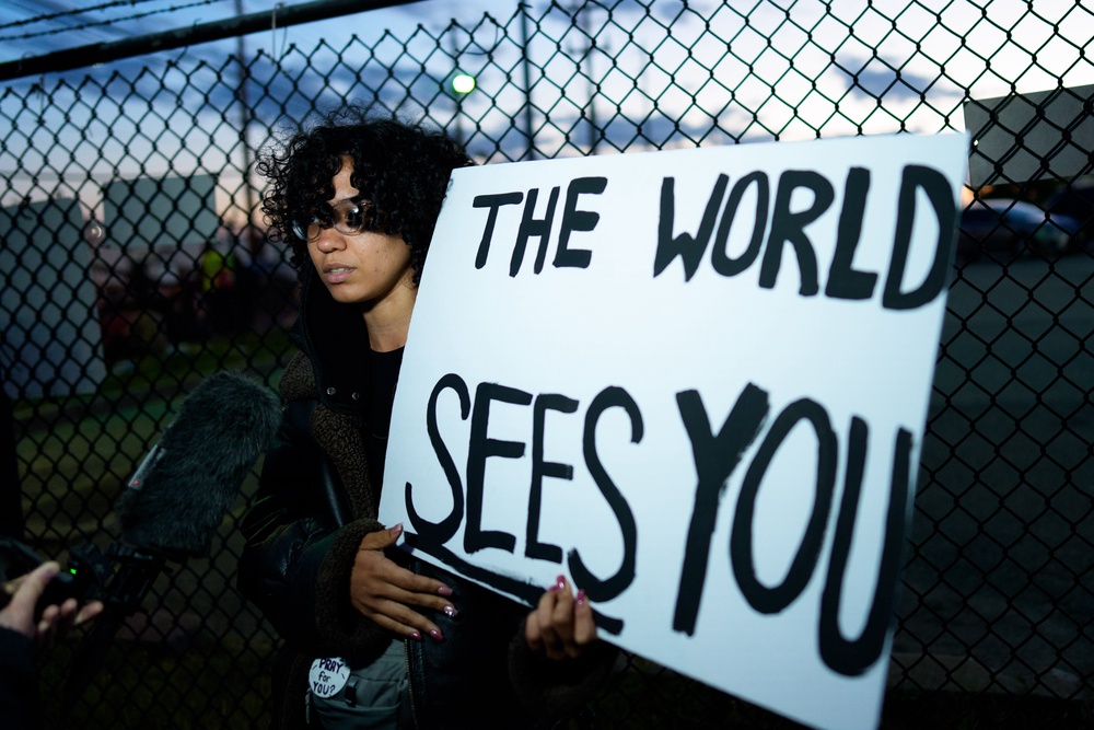A person holds a sign outside the Delaney Hall Immigration Detention Center in Newark, where ICE is housing detained immigrants (Getty)