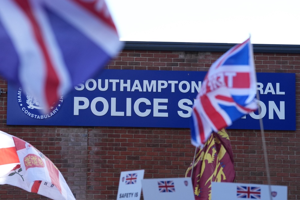 Members of the crowd waved Union flags during the protest (Gareth Fuller/PA) (PA Wire)