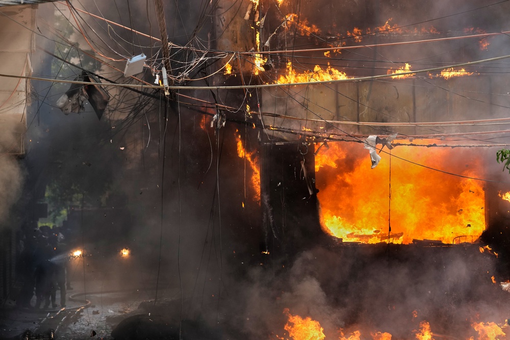 Firefighters work to put out the blaze (AP)