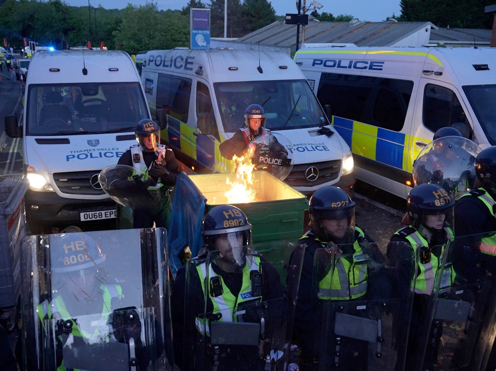 A bin was set on fire during the riot (PA)
