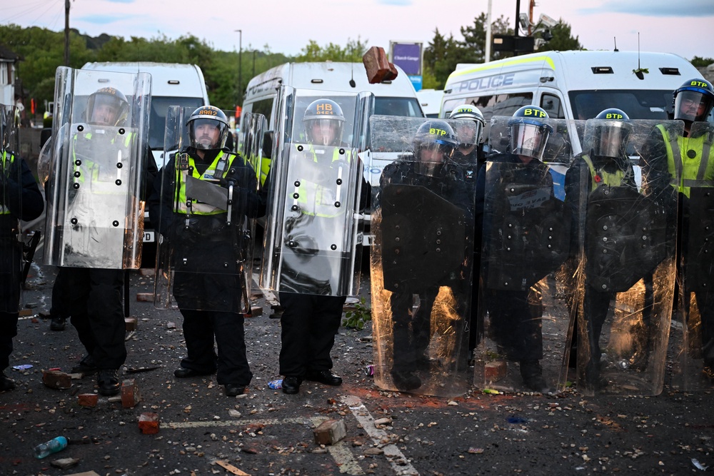 Protesters confront riot police near the location where Henry Nowak died, during a demonstration over the police’s handling of the incident (Getty)