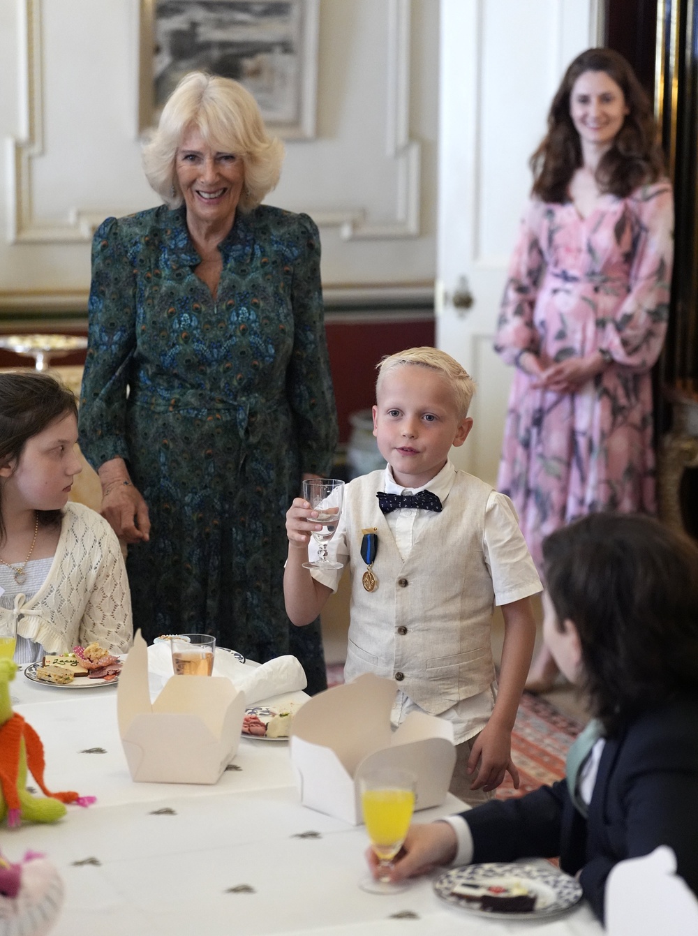 Rupert Williams, seven, raises a toast to Camilla (Andrew Matthews/PA) (PA Wire)