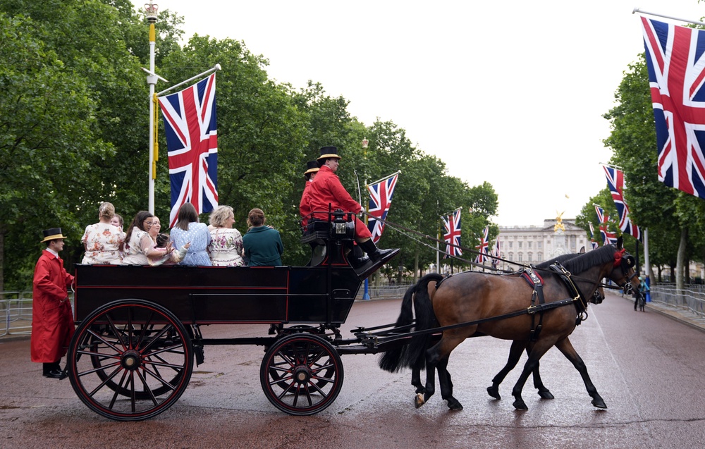 Children being driven by horse-drawn carriage down The Mall (Andrew Matthews/PA) (PA Wire)
