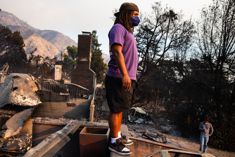 A young man looks out across the destruction from his family's home burned in the Eaton Fire in Altadena, California, in January 2025. Black Americans are at a higher risk of developing dementia (AFP via Getty Images)