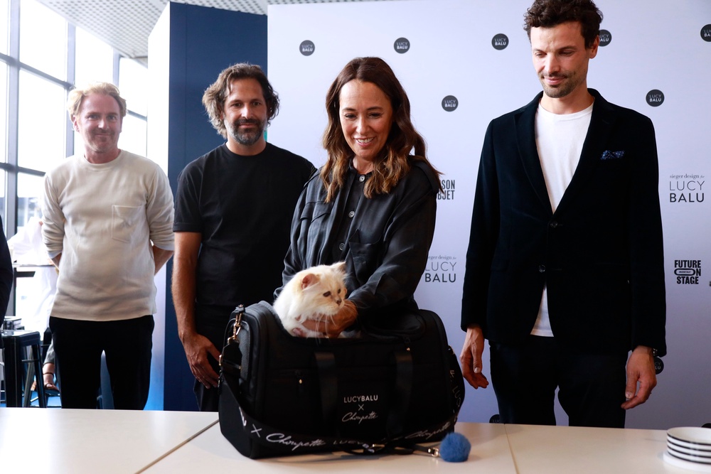Françoise Caçote (second from right), Choupette, and Lucas Bérullier (right) during a product presentation in Paris, France (Getty)