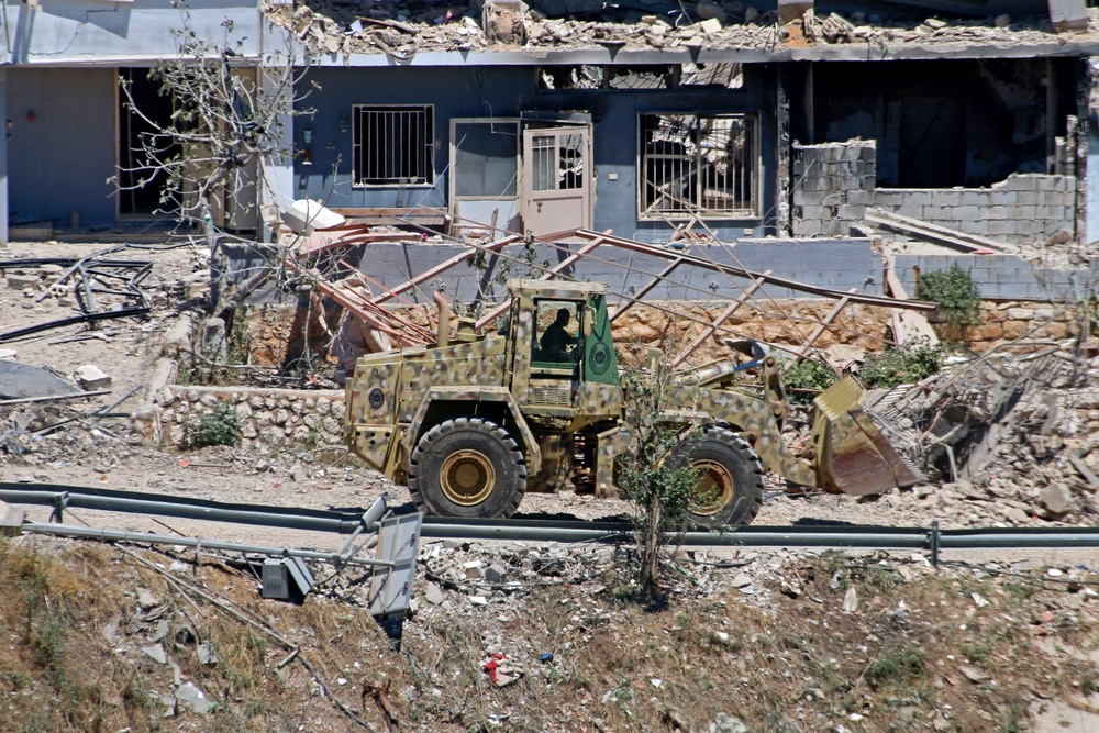 A Lebanese army bulldozer advances along the main road in the southern border village of Debbine on June 4, 2026, as the Israeli military reportedly begins a gradual withdrawal from the village. Israel carried out new strikes in Lebanon and again threatened Beirut, despite the two countries agreeing to a conditional ceasefire that Lebanon's president called the 