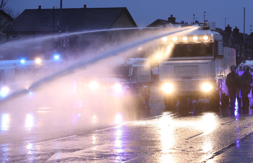 The PSNI use a water cannon during unrest in Belfast in 2021 (PA) (PA Archive)
