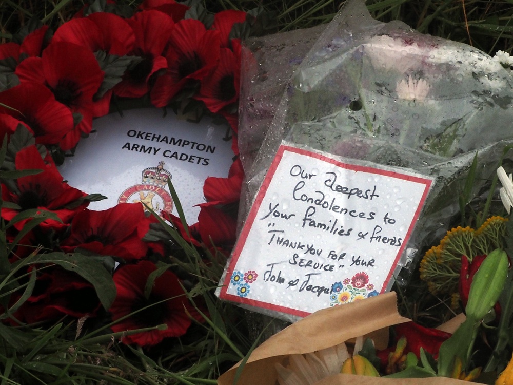Flowers left near the scene in Sourton Down, near Okehampton in Devon, where a Royal Navy helicopter crashed in a field (PA)