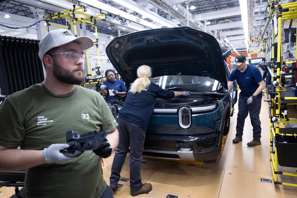 Since Trump took office, the US lost 77,000 manufacturing jobs. Pictured: Workers build Rivian R2 SUVs at the manufacturer's assembly plant on May 19, 2026 in Normal, Illinois (Getty)