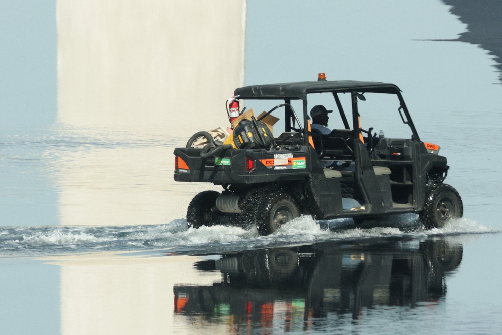 A worker drives through the newly-refilled Lincoln Memorial Reflecting Pool on Thursday (Getty)