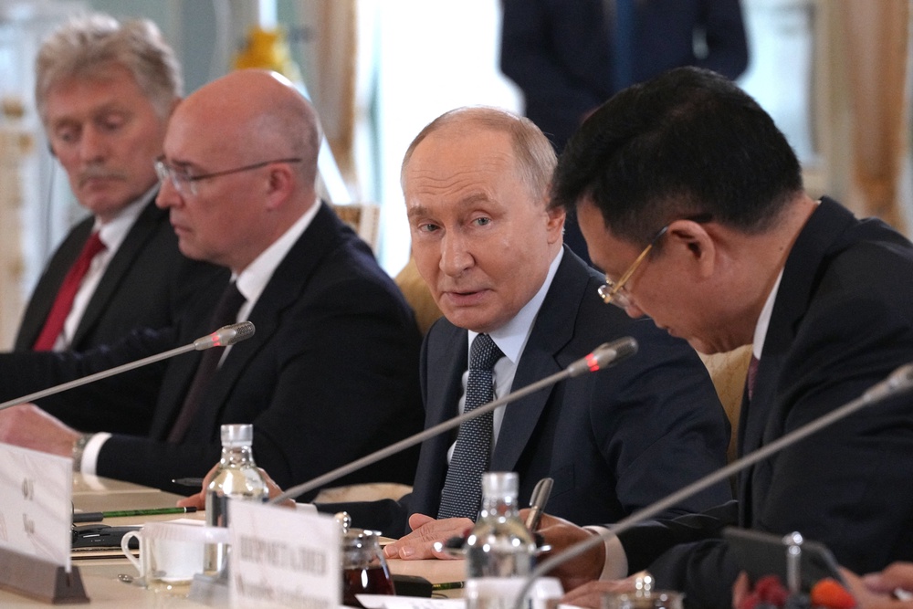 Russian president Vladimir Putin speaks to president of Xinhua News Agency Fu Hua during a meeting on the sidelines of the St. Petersburg International Economic Forum at the Constantine Palace in Saint Petersburg (AFP/Getty)