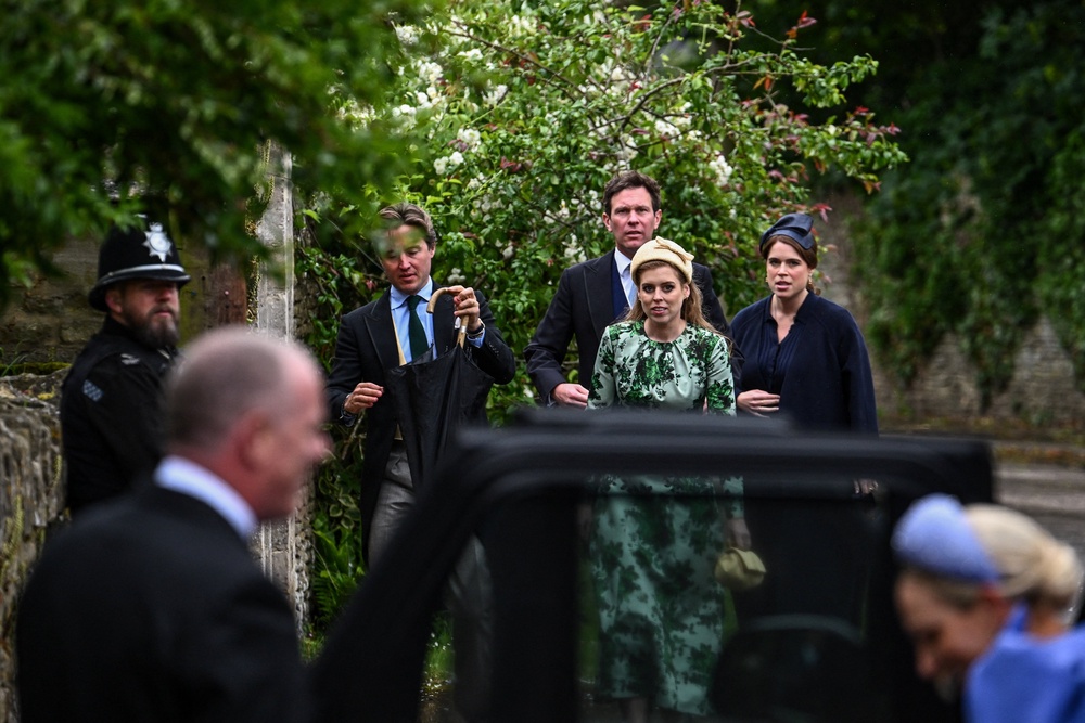 Britain's Princess Beatrice and Princess Eugenie arrive to attend the wedding of Princess Anne's son, Peter Phillips (Reuters)