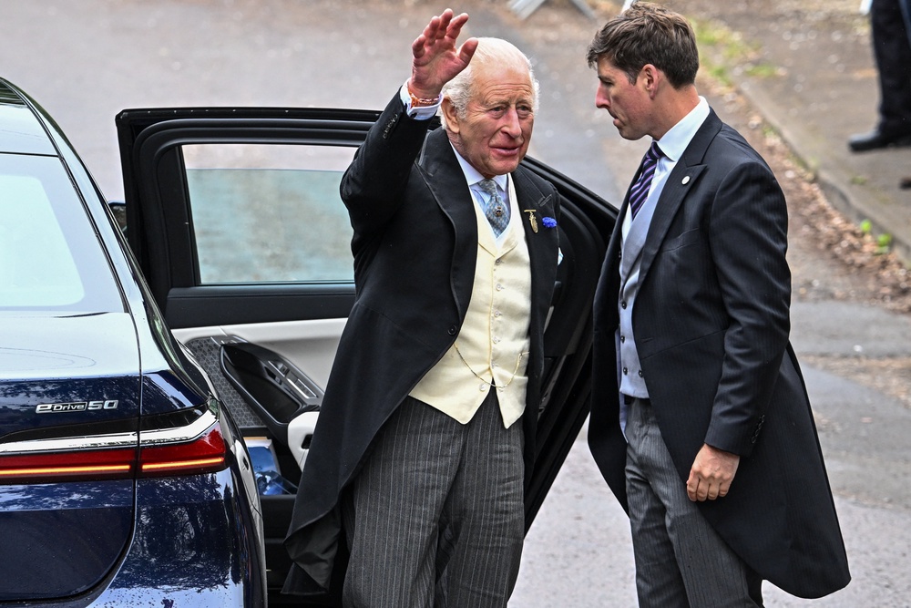King Charles waves as he arrives to attend the wedding of Princess Anne's son, Peter Phillips and Harriet Sperling at All Saints' Church (Reuters)