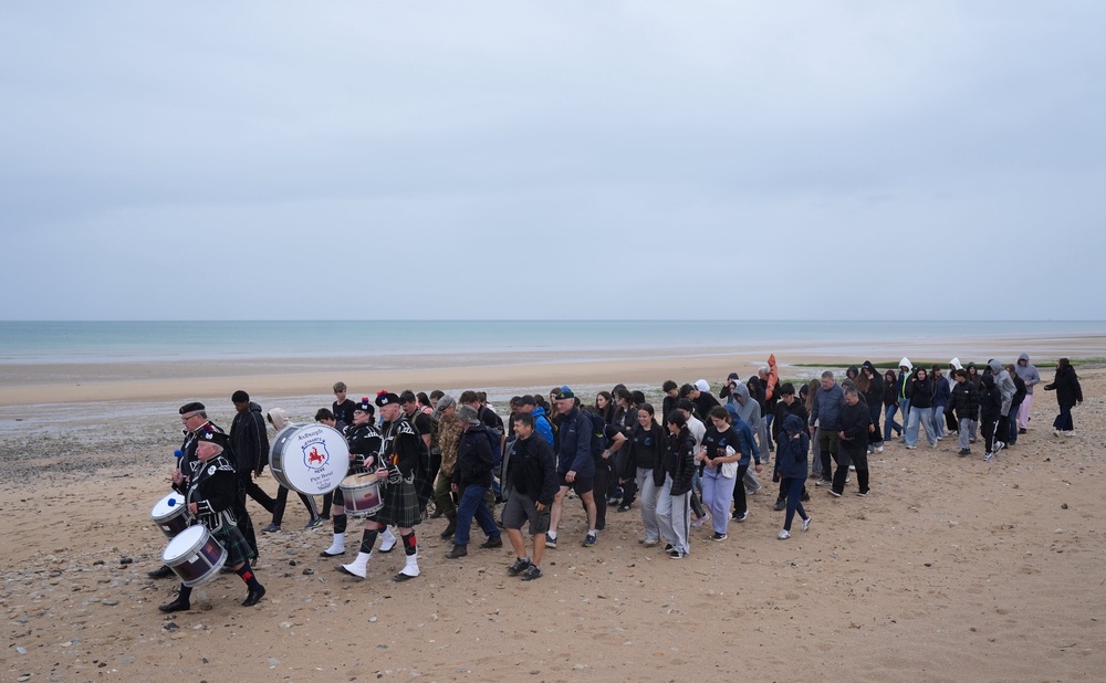 The Jedburgh Pipe Band lead walkers across Juno beach in Courseulles-sur-Mer at the end of a 22km walk along the French coastline taking in Sword, Juno and Gold beaches, in honour of the servicemen who landed there more than 80 years ago (Gareth Fuller/PA) (PA Wire)