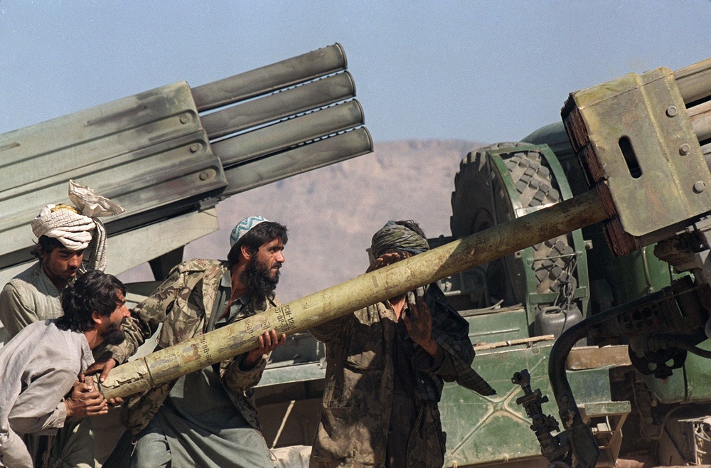 Taliban gunners reload an BM-21 multi-barrel rocket launcher on the frontline in 1996 (AFP/Getty)