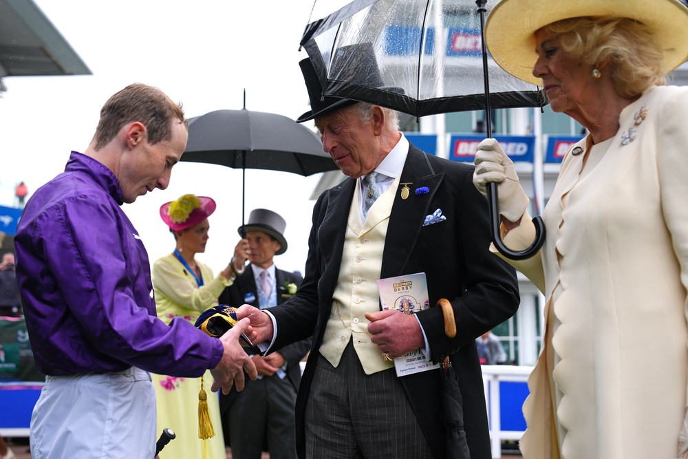 Jockey Rowan Scott is presented with a cap by the King (Carl Court/PA) (PA Wire)