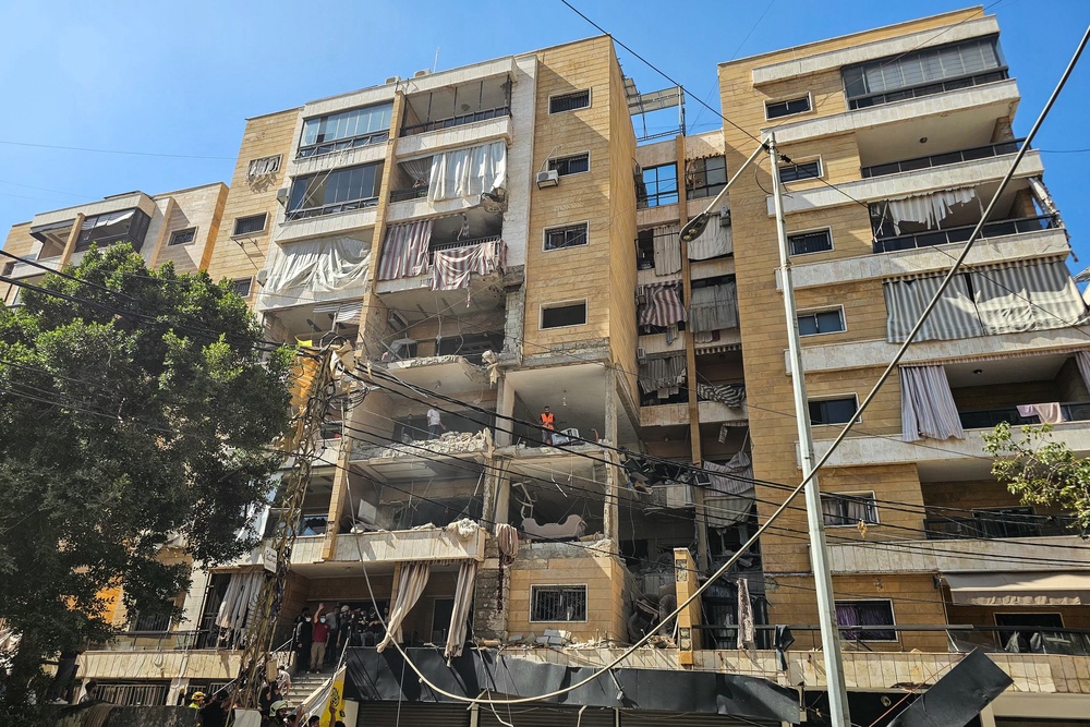 First responders inspect damage at the site of an Israeli airstrike on an apartment building in Beirut (AFP/Getty)
