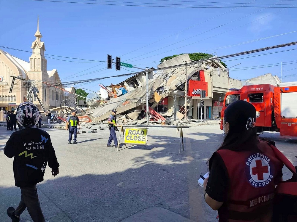 Rescuers inspect the damage after an earthquake in General Santos, Philippines (AP)