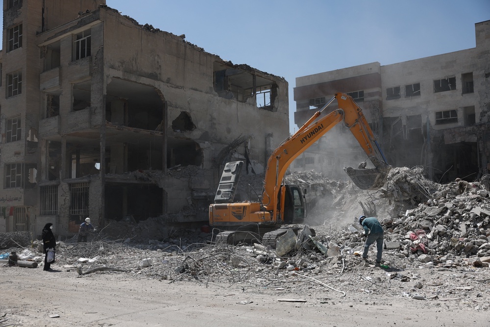 A machine operates near a residential building, which was damaged in a U.S. and Israeli strike in March, in Tehran, Iran June 7 (Reuters)