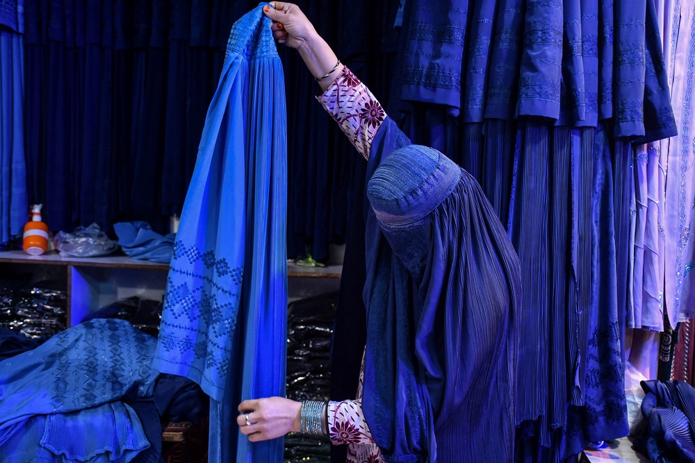 In this picture taken on February 20, 2025, an Afghan woman buys burqas at a shop in Mazar-i-Sharif. Since, the Taliban authorities came back to power in Kabul, in August 2021, they have imposed broad restrictions on women based on a strict interpretation of Islamic law (AFP/Getty)