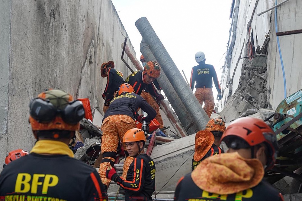 Responders conduct a rescue operation at a collapsed building after a 7.8 magnitude earthquake in General Santos City (AFP/Getty)