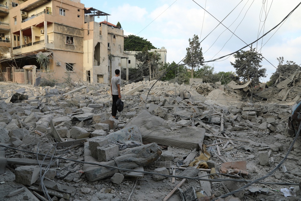 A man stands amid debris following Israeli airstrikes that hit the previous day, near the archaeological site of the Roman baths in the southern Lebanese city of Tyre on June 8 (AFP/Getty)
