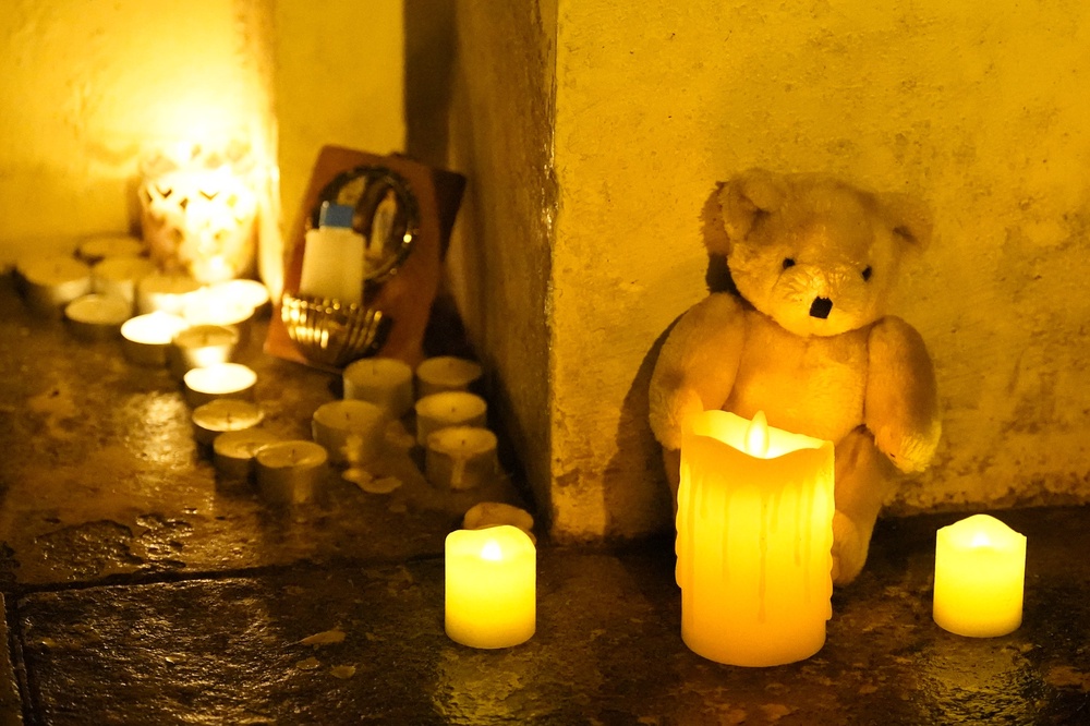 Candles and tributes left at the scene in 2023 (Niall Carson/PA) (PA Archive)