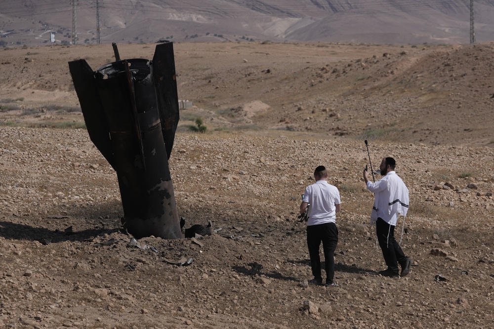 People inspect the wreckage of an Iranian missile that landed near the West Bank city of Jericho (Mahmoud Illean/AP) (AP)