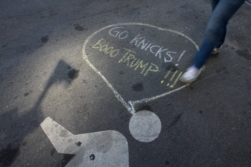 A chalk message outside Madison Square Garden that reads, 'Go Knicks! Booo Trump!!!' (REUTERS)