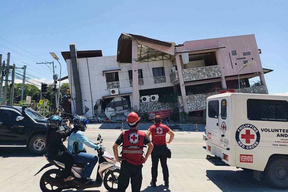 Rescuers in General Santos city inspect the damage after the earthquake (Philippine Red Cross/AP)