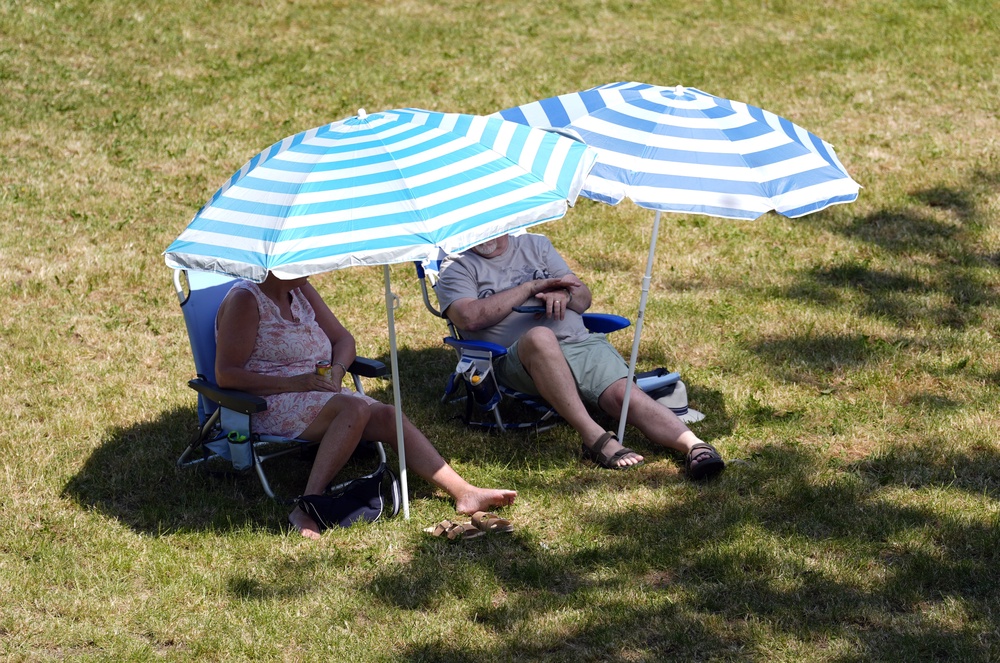 People shelter under parasols in Wallingford, Oxfordshire (Andrew Matthews/PA) (PA Wire)