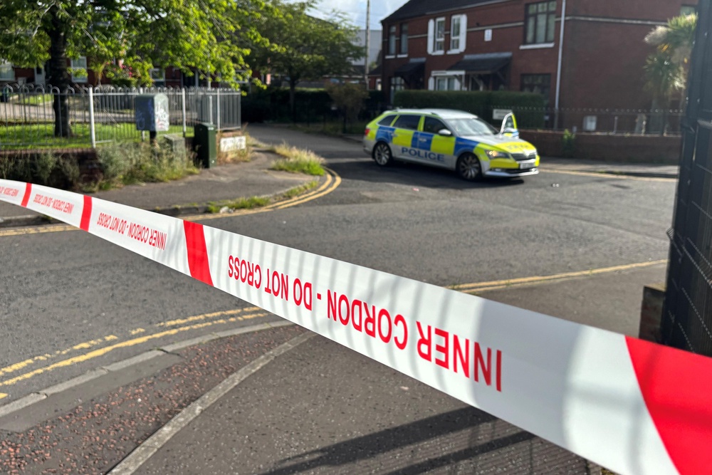 A police cordon at the scene of a stabbing outside apartments in the Kinnaird Avenue area of north Belfast (PA)