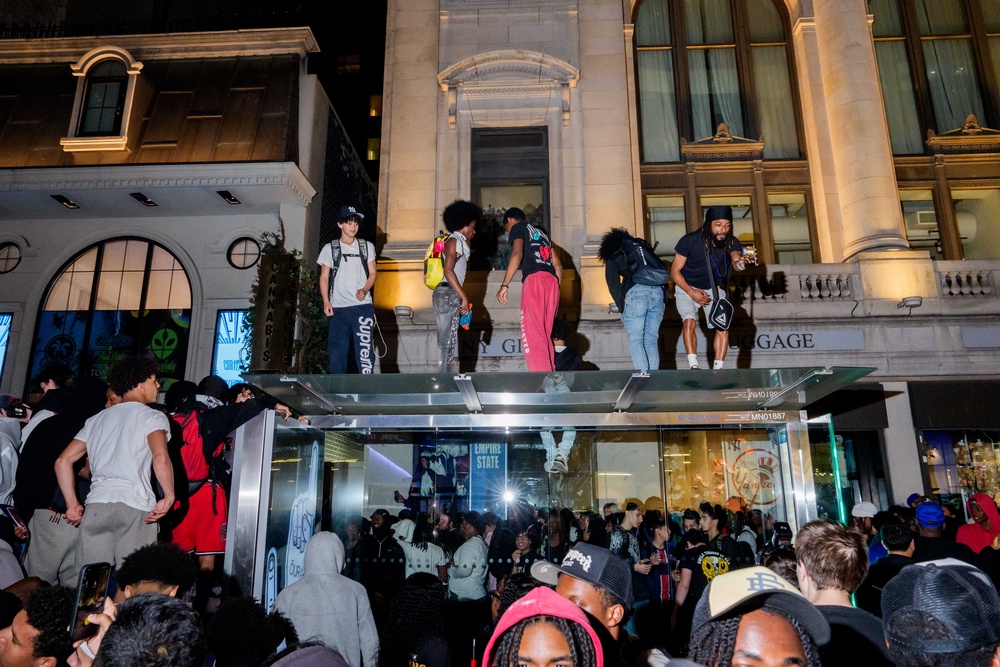 Fans climb on top of a bus stop during the chaos (Getty)