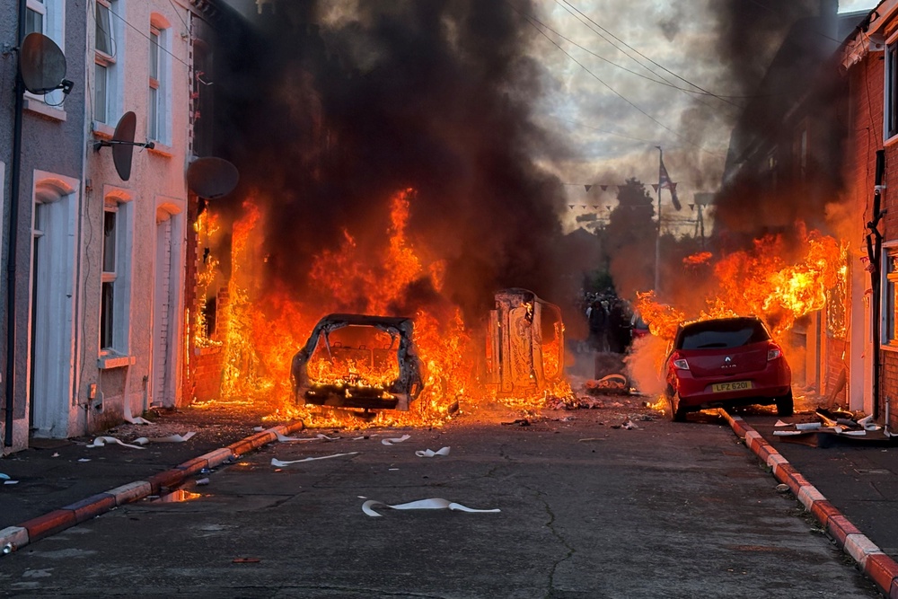 Vehicles were set on fire by protesters on Lendrick Street in Belfast (PA Wire)