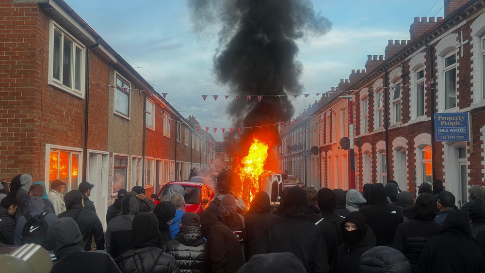 Vehicles set on fire by protesters on Lendrick Street in Belfast (PA)