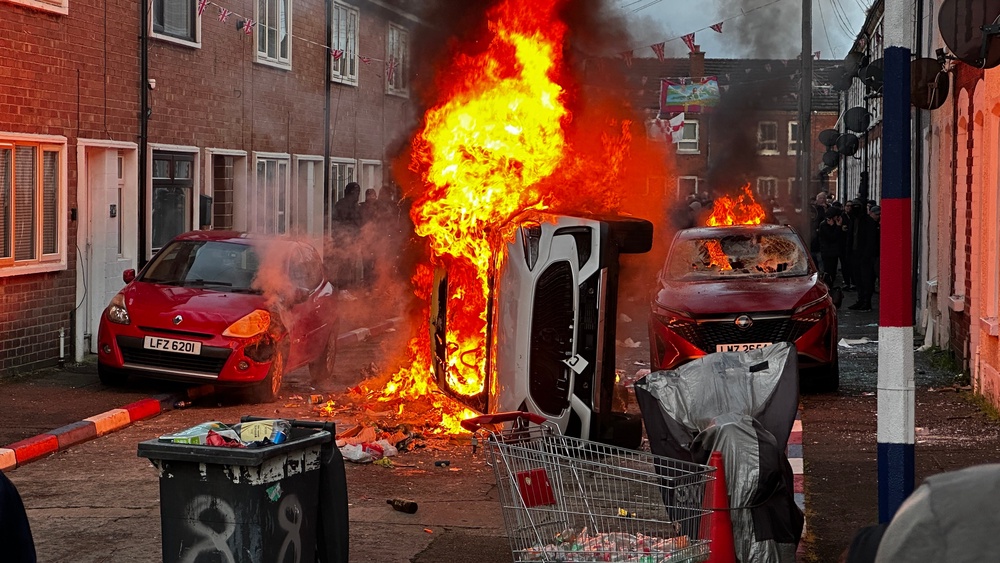 Vehicles set on fire by protesters on Lendrick Street (PA)