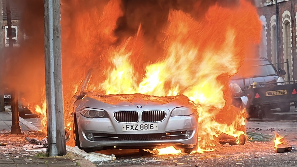 A car set on fire by protesters in east Belfast on Tuesday (PA) (PA Wire)