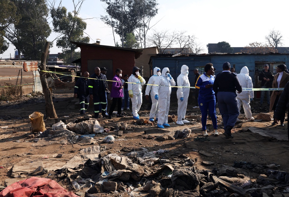 Members of the forensics team arrive at the scene after, according to the police, gunmen opened fire at an informal settlement in Cleveland, Johannesburg, South Africa,  June 10, 2026. REUTERS/Siphiwe Sibeko (Reuters)