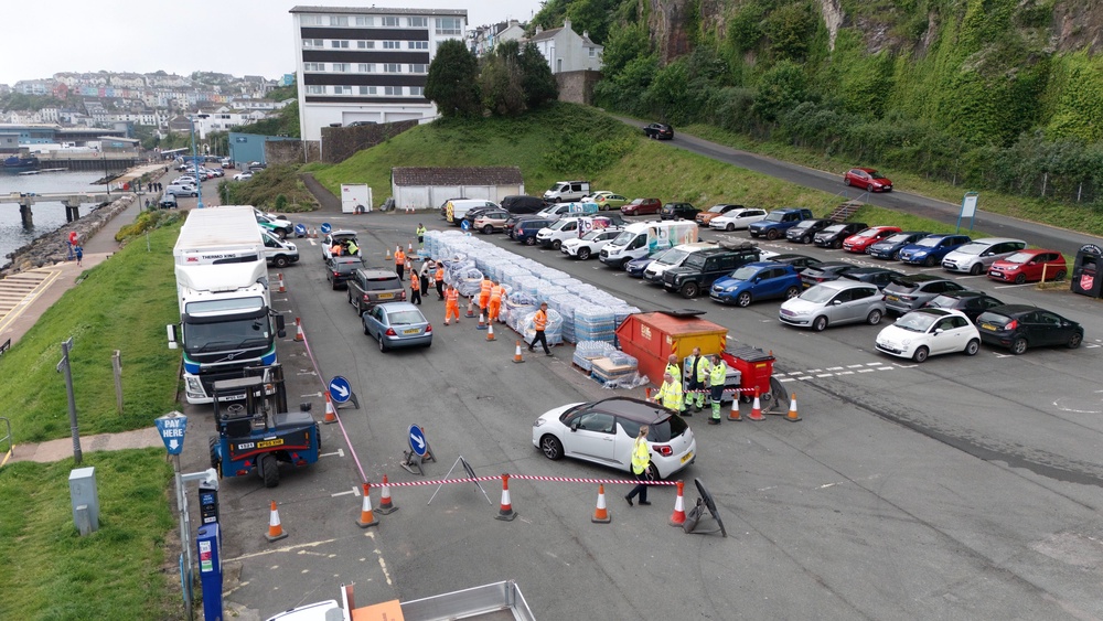 People collecting bottled water at Freshwater car park in Brixham in May 2024 (Ben Birchall/PA) (PA Archive)