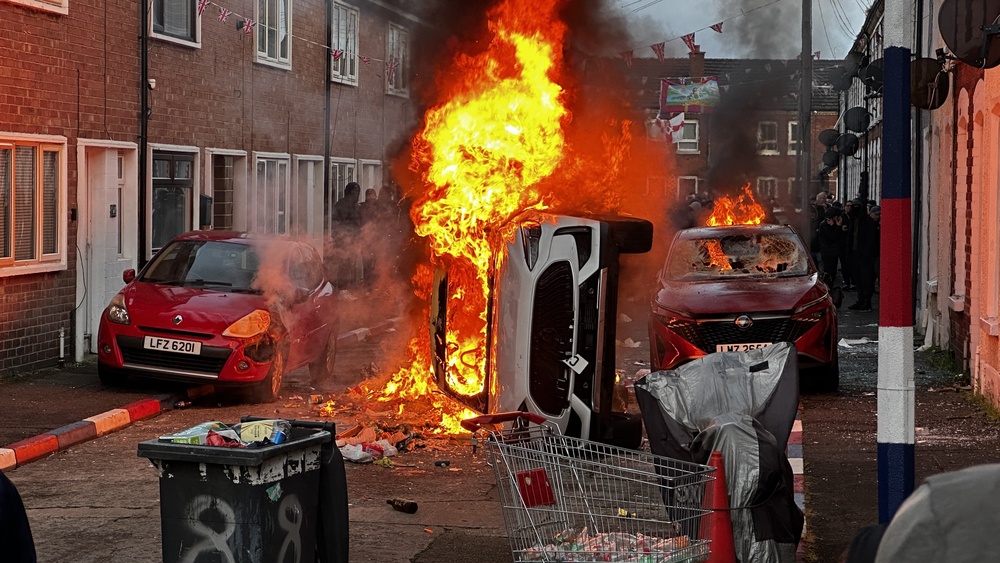 The scene on Lendrick Street on Tuesday night after a mob set fire to houses and cars (PA Wire)